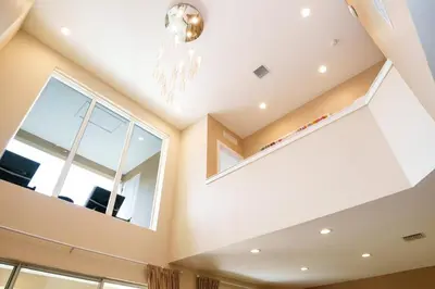 a living room with a chandelier and large windows at Disney Escape Modern 3BR Townhouse 2 Miles to the Parks 4 Baths in Orlando