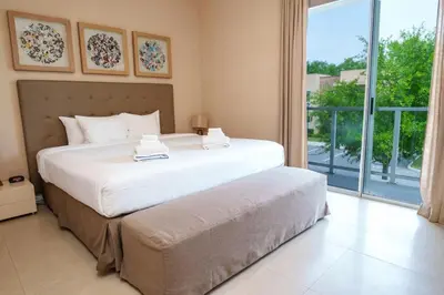a bedroom with a large bed and a large window at Disney Escape Modern 3BR Townhouse 2 Miles to the Parks 4 Baths in Orlando