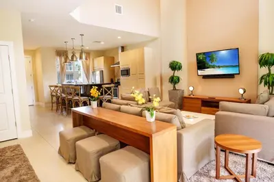 a living room with a couch and a table at Disney Escape Modern 3BR Townhouse 2 Miles to the Parks 4 Baths in Orlando