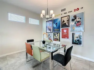 a dining room with a glass table and chairs at Beautiful 3bed 2bath Condo close to Disney Parks 344 in Kissimmee