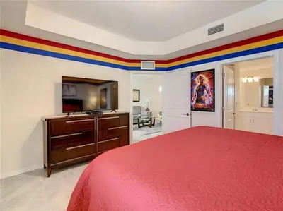 a bedroom with a red bed and a rainbow border at Beautiful 3bed 2bath Condo close to Disney Parks 344 in Kissimmee