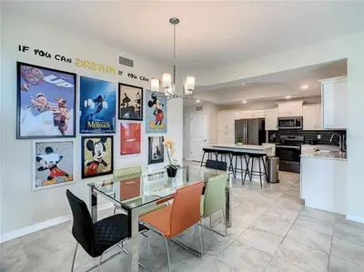 a kitchen and dining room with a glass table and chairs at Beautiful 3bed 2bath Condo close to Disney Parks 344 in Kissimmee