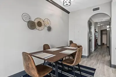a dining room with a wooden table and chairs at LUXURY 1br LAKEVIEW CONDO NEAR DISNEY! in Orlando