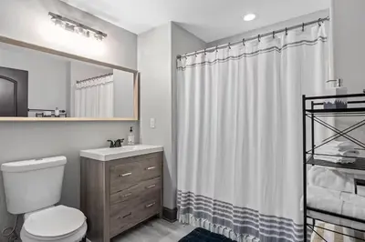 a bathroom with a toilet and a shower curtain at LUXURY 1br LAKEVIEW CONDO NEAR DISNEY! in Orlando