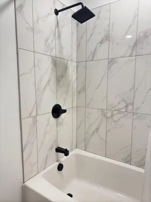 a white bathroom with a shower with a sink at Modern 1 bedroom Apartment and Den in Orlando in Orlando