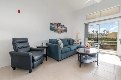 a living room with a couch and two chairs and a table at Family Home w/ Pool & Water Views, Near Disney in Kissimmee