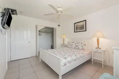 a bedroom with a bed and a ceiling fan at Family Home w/ Pool & Water Views, Near Disney in Kissimmee