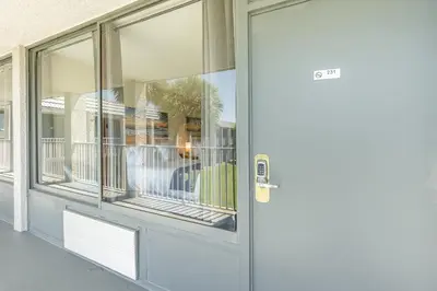 a front door of a house with windows at Charming Suite: Smart TV, Modern Amenities & Pool Access in Kissimmee