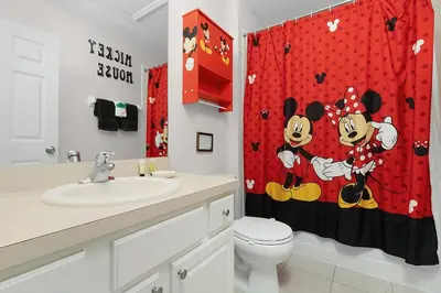 a bathroom with a toilet and a shower curtain at Windsor Hills Home with Pool & Near Disney in Orlando
