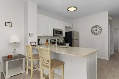 a kitchen with a counter and chairs and a counter top at Windsor Hills Home with Pool & Near Disney in Orlando