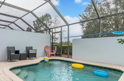 a swimming pool with four frisbees in the water at Windsor Hills Home with Pool & Near Disney in Orlando
