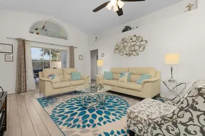 a living room with two couches and a rug at Indian Ridge Home w/ Private Pool & Game Room near Disney in Orlando