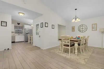 a kitchen and dining room with a table and chairs at Indian Ridge Home w/ Private Pool & Game Room near Disney in Orlando