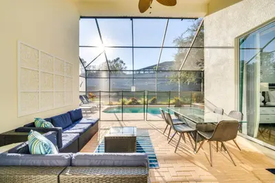 a living room with a couch and a glass table at 3 Mi to Disney Family-Friendly Home! in Orlando