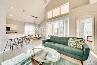 a living room with a green couch and a table at 3 Mi to Disney Family-Friendly Home! in Orlando