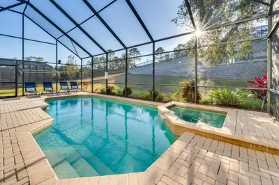 an indoor swimming pool with a glass house at 3 Mi to Disney Family-Friendly Home! in Orlando