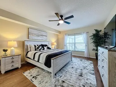 a bedroom with a bed and a ceiling fan at Emerald Island Four Bed Pool Home close to Disney villa in Kissimmee
