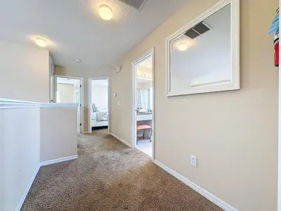 a living room with a kitchen and a hallway at Emerald Island Four Bed Pool Home close to Disney villa in Kissimmee