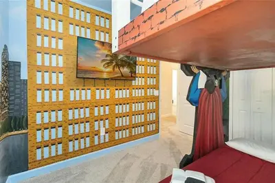 a bedroom with a mural of a building at Fantastic Home 7BR5BA with Private Pool Storey Lake Resort SL2648 in Kissimmee