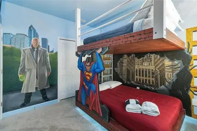a bedroom with a superhero mural on the wall at Fantastic Home 7BR5BA with Private Pool Storey Lake Resort SL2648 in Kissimmee
