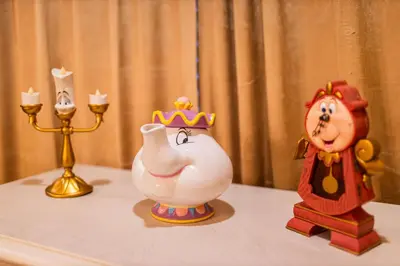 a table topped with toy figurines of a princess and a crown at Disney Dream House com 12 Themed Bedrooms 5851 in Orlando