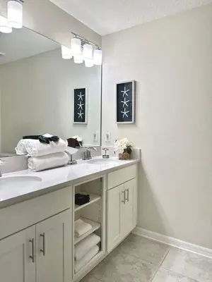 a bathroom with a sink and a large mirror at 2 Bedroom Condo minutes from Disney 325 in Kissimmee