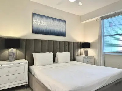 a bedroom with a large bed and two night stands at 2 Bedroom Condo minutes from Disney 325 in Kissimmee