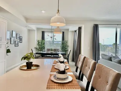a dining room and living room with a table and chairs at My condo 2bd 2bth close to Disney World 315 in Kissimmee