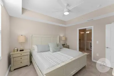 a white bedroom with a bed and a ceiling fan at 3141-104 Resort Lake View Disney Universal Orlando in Kissimmee