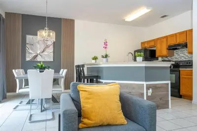a kitchen and living room with a couch and a table at 4 bedrooms close to Disney in Kissimmee