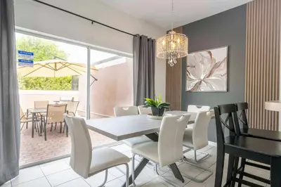 a dining room with a table and white chairs at 4 bedrooms close to Disney in Kissimmee