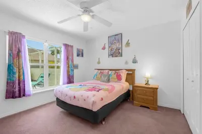 a bedroom with a bed and a dresser and a window at Upstay - Games & Private Pool Family Home in Orlando