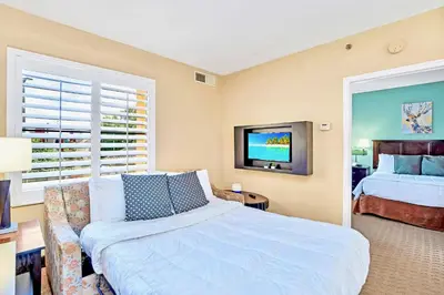 a bedroom with a bed and a couch and a tv at Suite with Pool and Hot Tub - Close to Near Disney in Orlando