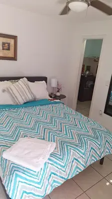 a bed with two towels on it in a bedroom at Private Studio in Kissimmee