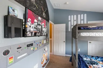 a bedroom with a bunk bed and a tv on a wall at Escape to Luxury in Orlando Villa6492 in Orlando