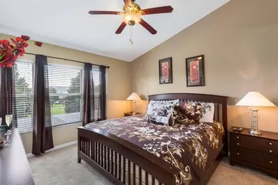 a bedroom with a bed and a ceiling fan at Escape to Luxury in Orlando Villa6492 in Orlando