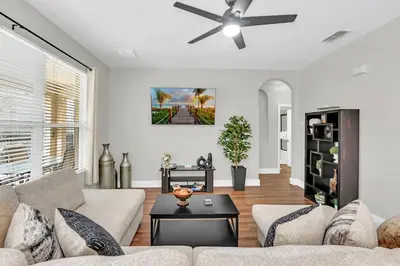 a living room with a couch and a ceiling fan at Dreamy 6 Bedroom Villa in Orlando6495 in Orlando