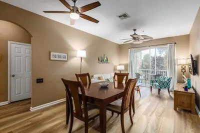 a dining room and living room with a table and chairs at Stunning 2 Bedroom Retreat in Orlando6496 in Orlando