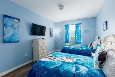 a blue bedroom with two beds and a tv at Stunning 2 Bedroom Retreat in Orlando6496 in Orlando