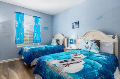 a bedroom with two beds with blue walls at Stunning 2 Bedroom Retreat in Orlando6496 in Orlando