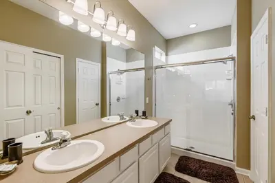 a bathroom with two sinks and a shower at Charming Orlando Villa with 5 Bedrooms6499 in Orlando