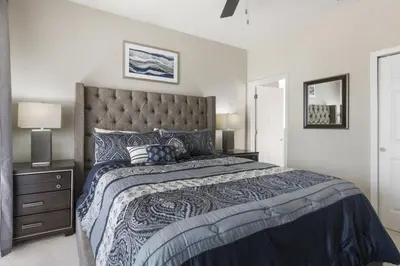 a bedroom with a large bed with a large headboard at Orlando Dream Home - 4 Bed Villa6501 in Orlando