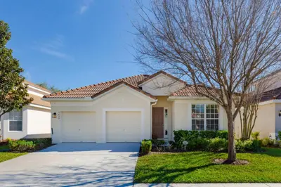 a white house with a tree in front of it at Orlando Dream Home - 4 Bed Villa6501 in Orlando