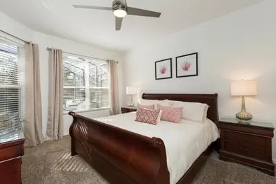 a bedroom with a large bed and a ceiling fan at Orlando Oasis: 5 Bedroom Villa6502 in Orlando