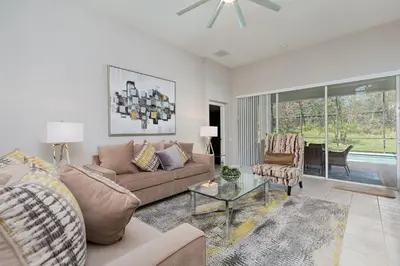 a living room with a couch and a table at Orlando Oasis: 5 Bedroom Villa6502 in Orlando