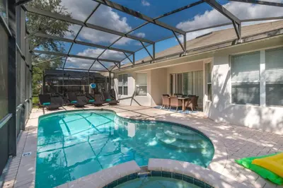 an indoor swimming pool with a glass roof at Orlando Oasis: 5 Bedroom Villa6502 in Orlando
