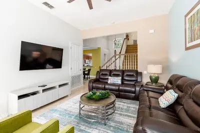 a living room with leather furniture and a flat screen tv at Orlando Oasis: 5 Bed Villa6504 in Orlando