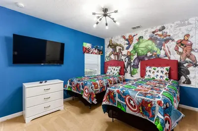 a bedroom with two beds and a marvel mural at Orlando Oasis: 5 Bed Villa6504 in Orlando