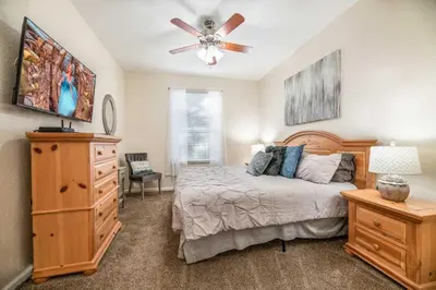 a bedroom with a bed with a ceiling fan and a dresser at Orlando Paradise: 3 Bed Condo6505 in Orlando