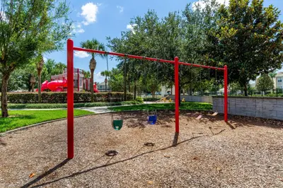 a red swing set in a park at Orlando Paradise: 3 Bed Condo6505 in Orlando
